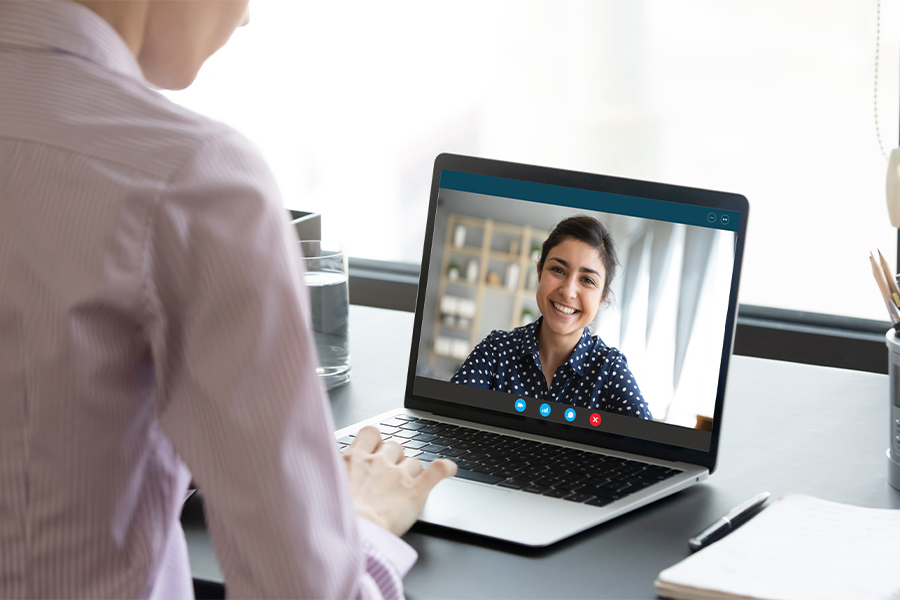 Man speaking to clinician on laptop. 